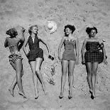 Four Models Showing Off the Latest Bathing Suit Fashions While Lying on a Sandy Florida Beach-Nina Leen-Photographic Print