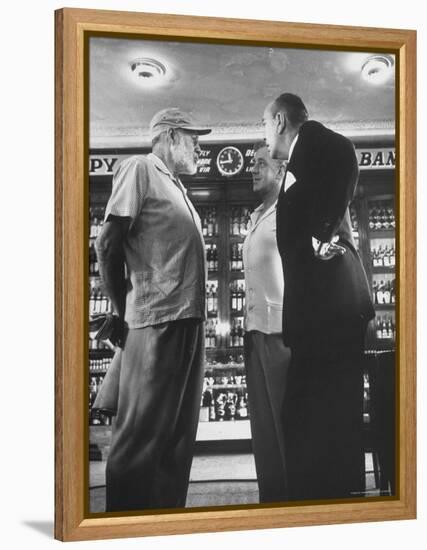 Noel Coward Chatting with Ernest Hemingway and Alec Guinness on Set Location at Sloppy Joe's Bar-Peter Stackpole-Framed Premier Image Canvas