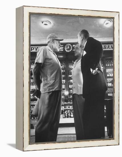 Noel Coward Chatting with Ernest Hemingway and Alec Guinness on Set Location at Sloppy Joe's Bar-Peter Stackpole-Framed Premier Image Canvas