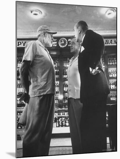 Noel Coward Chatting with Ernest Hemingway and Alec Guinness on Set Location at Sloppy Joe's Bar-Peter Stackpole-Mounted Premium Photographic Print