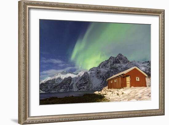 Northern Lights (Aurora Borealis) Illuminate Snowy Peaks and Wooden Cabin on a Starry Night-Roberto Moiola-Framed Photographic Print