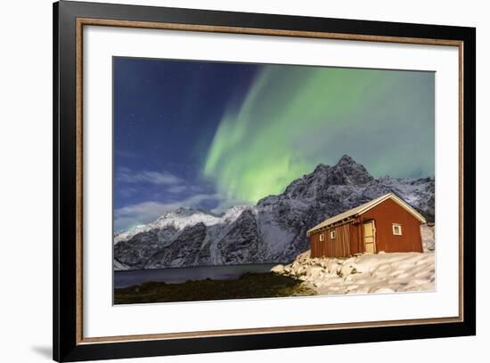 Northern Lights (Aurora Borealis) Illuminate Snowy Peaks and Wooden Cabin on a Starry Night-Roberto Moiola-Framed Photographic Print