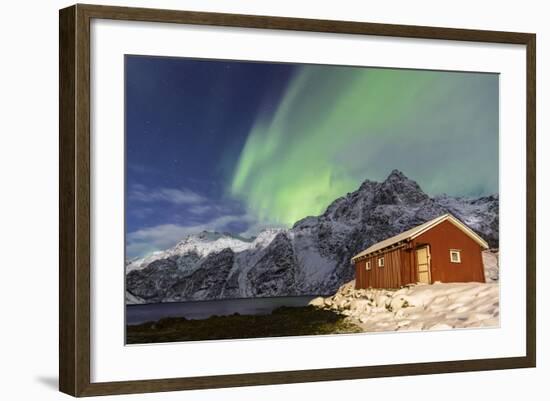 Northern Lights (Aurora Borealis) Illuminate Snowy Peaks and Wooden Cabin on a Starry Night-Roberto Moiola-Framed Photographic Print