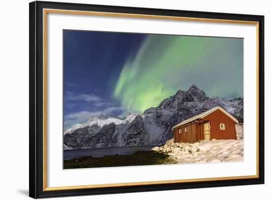 Northern Lights (Aurora Borealis) Illuminate Snowy Peaks and Wooden Cabin on a Starry Night-Roberto Moiola-Framed Photographic Print