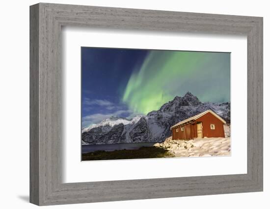 Northern Lights (Aurora Borealis) Illuminate Snowy Peaks and Wooden Cabin on a Starry Night-Roberto Moiola-Framed Photographic Print