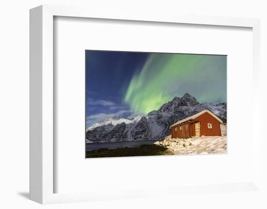 Northern Lights (Aurora Borealis) Illuminate Snowy Peaks and Wooden Cabin on a Starry Night-Roberto Moiola-Framed Photographic Print