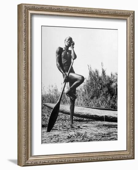 Nuer Tribesman Standing Like a Stork Next to His Canoe in a Papyrus Swamp-Eliot Elisofon-Framed Photographic Print
