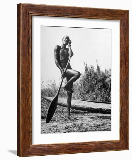 Nuer Tribesman Standing Like a Stork Next to His Canoe in a Papyrus Swamp-Eliot Elisofon-Framed Photographic Print