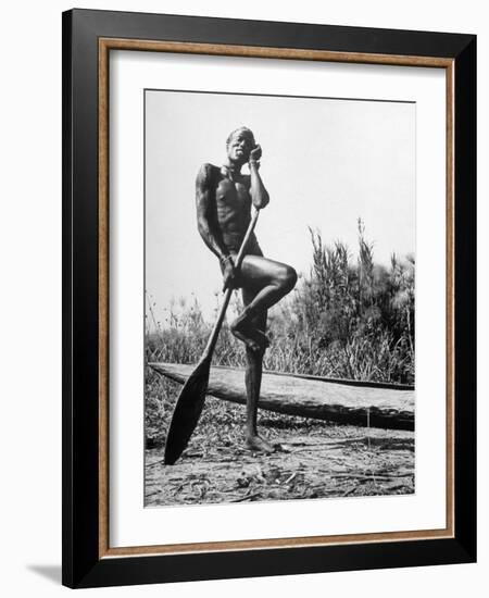 Nuer Tribesman Standing Like a Stork Next to His Canoe in a Papyrus Swamp-Eliot Elisofon-Framed Photographic Print