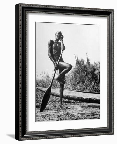 Nuer Tribesman Standing Like a Stork Next to His Canoe in a Papyrus Swamp-Eliot Elisofon-Framed Photographic Print