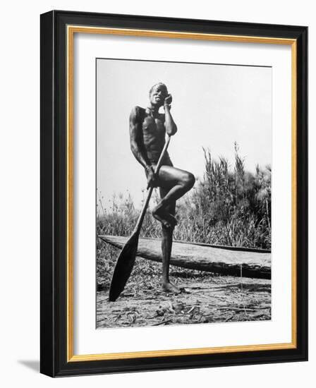 Nuer Tribesman Standing Like a Stork Next to His Canoe in a Papyrus Swamp-Eliot Elisofon-Framed Photographic Print