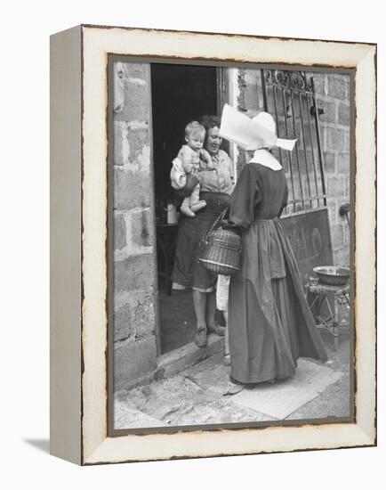 Nun from the Order of Sisters of Charity Visiting a Destitute Family with Supplies-null-Framed Premier Image Canvas