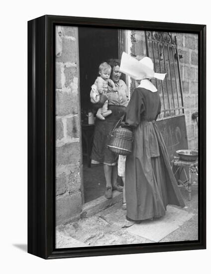 Nun from the Order of Sisters of Charity Visiting a Destitute Family with Supplies-null-Framed Premier Image Canvas