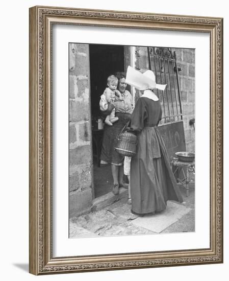 Nun from the Order of Sisters of Charity Visiting a Destitute Family with Supplies-null-Framed Photographic Print