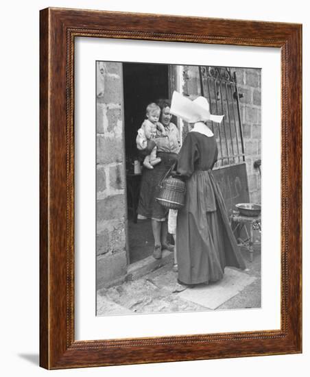 Nun from the Order of Sisters of Charity Visiting a Destitute Family with Supplies-null-Framed Photographic Print