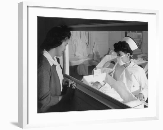 Nurse Aiko Hamaguchi shows new baby to mother in maternity ward, Manzanar War Relocation Center, CA-Ansel Adams-Framed Photographic Print