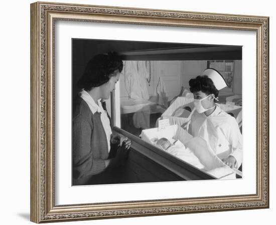 Nurse Aiko Hamaguchi shows new baby to mother in maternity ward, Manzanar War Relocation Center, CA-Ansel Adams-Framed Photographic Print
