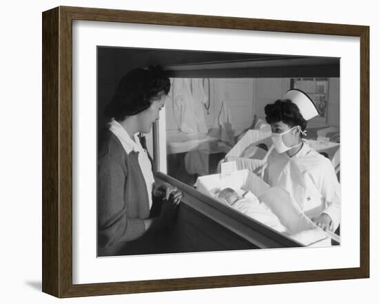 Nurse Aiko Hamaguchi shows new baby to mother in maternity ward, Manzanar War Relocation Center, CA-Ansel Adams-Framed Photographic Print