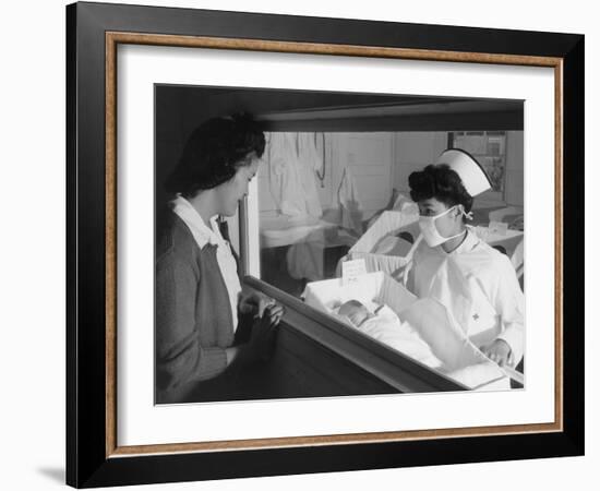 Nurse Aiko Hamaguchi shows new baby to mother in maternity ward, Manzanar War Relocation Center, CA-Ansel Adams-Framed Photographic Print