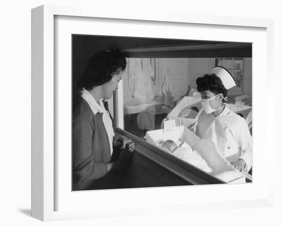 Nurse Aiko Hamaguchi shows new baby to mother in maternity ward, Manzanar War Relocation Center, CA-Ansel Adams-Framed Photographic Print