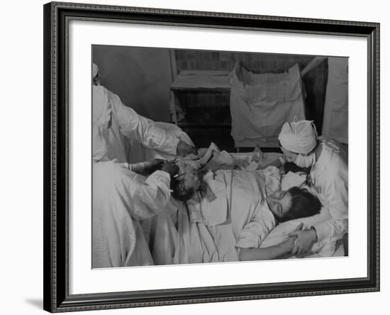 Nurse at Her Head and Holding Her Hands, as She Gazes at Her Baby Boy after "Painless" Childbirth-Alfred Eisenstaedt-Framed Premium Photographic Print