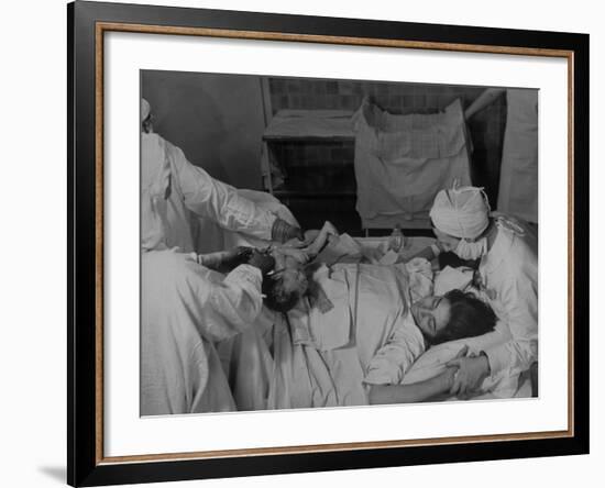 Nurse at Her Head and Holding Her Hands, as She Gazes at Her Baby Boy after "Painless" Childbirth-Alfred Eisenstaedt-Framed Premium Photographic Print