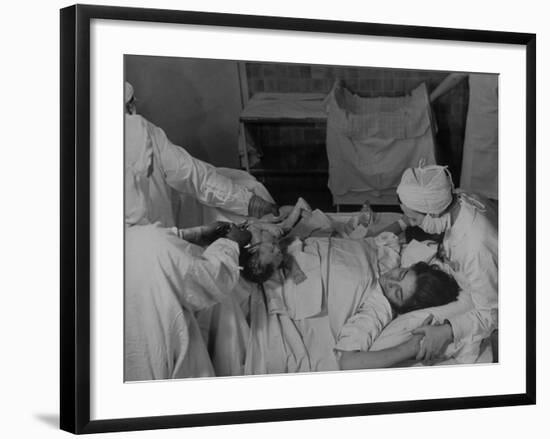 Nurse at Her Head and Holding Her Hands, as She Gazes at Her Baby Boy after "Painless" Childbirth-Alfred Eisenstaedt-Framed Premium Photographic Print