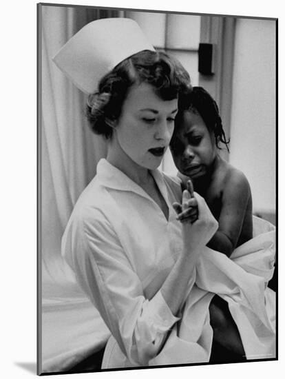 Nurse Holding African American Girl in Her Arms, Examining Her Finger-John Dominis-Mounted Photographic Print