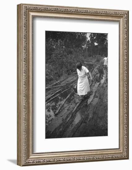 Nurse Maude Callen Carrying Her Medical Bag Along a Muddy Road after Caring for a Patient, 1951-W^ Eugene Smith-Framed Photographic Print