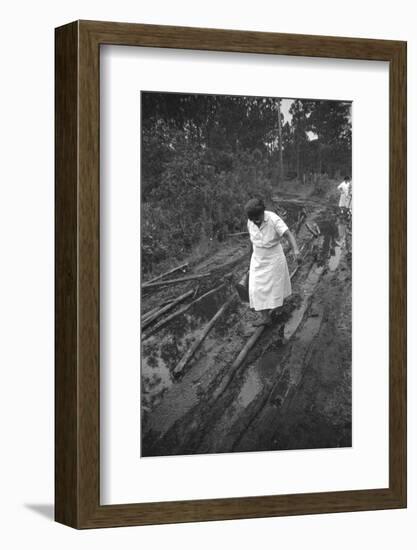 Nurse Maude Callen Carrying Her Medical Bag Along a Muddy Road after Caring for a Patient, 1951-W^ Eugene Smith-Framed Photographic Print