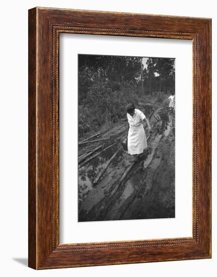 Nurse Maude Callen Carrying Her Medical Bag Along a Muddy Road after Caring for a Patient, 1951-W^ Eugene Smith-Framed Photographic Print