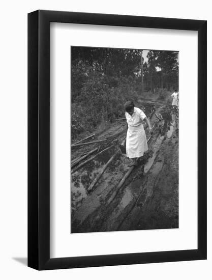 Nurse Maude Callen Carrying Her Medical Bag Along a Muddy Road after Caring for a Patient, 1951-W^ Eugene Smith-Framed Photographic Print