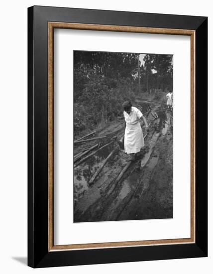 Nurse Maude Callen Carrying Her Medical Bag Along a Muddy Road after Caring for a Patient, 1951-W^ Eugene Smith-Framed Photographic Print