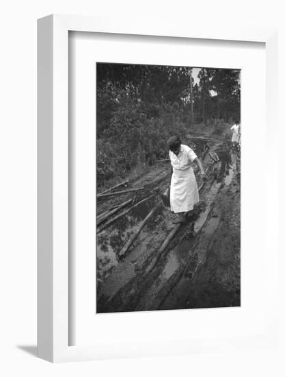 Nurse Maude Callen Carrying Her Medical Bag Along a Muddy Road after Caring for a Patient, 1951-W^ Eugene Smith-Framed Photographic Print