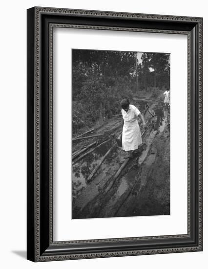 Nurse Maude Callen Carrying Her Medical Bag Along a Muddy Road after Caring for a Patient, 1951-W^ Eugene Smith-Framed Photographic Print