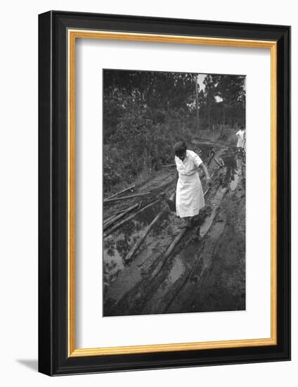 Nurse Maude Callen Carrying Her Medical Bag Along a Muddy Road after Caring for a Patient, 1951-W^ Eugene Smith-Framed Photographic Print