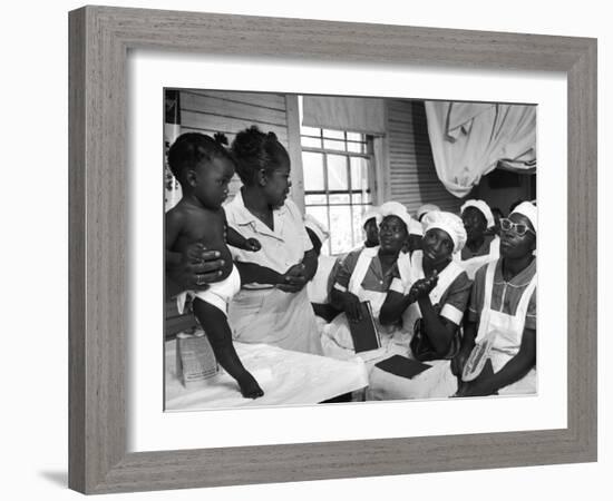 Nurse/Midwife Maude Callen Holds Baby and Teaches Class in Midwifery How to Look for Abnormalities-W^ Eugene Smith-Framed Photographic Print