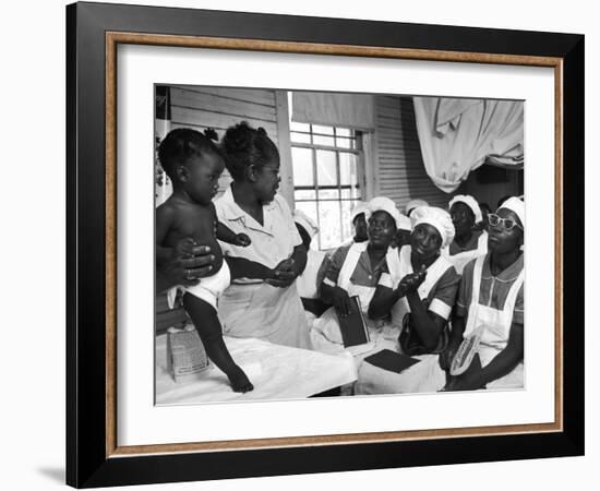 Nurse/Midwife Maude Callen Holds Baby and Teaches Class in Midwifery How to Look for Abnormalities-W^ Eugene Smith-Framed Photographic Print