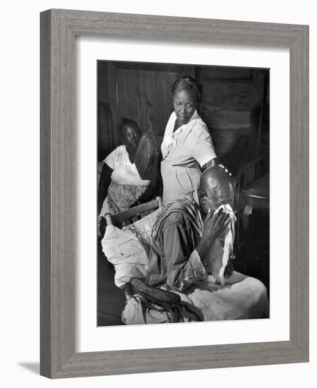 Nurse Midwife Maude Callen Tenderly Caring for an Old Chair-Bound Paralytic Touched by Her Kindness-W^ Eugene Smith-Framed Photographic Print