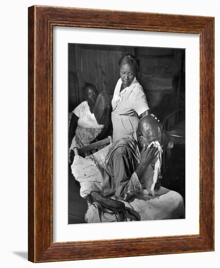 Nurse Midwife Maude Callen Tenderly Caring for an Old Chair-Bound Paralytic Touched by Her Kindness-W^ Eugene Smith-Framed Photographic Print