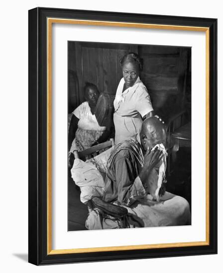 Nurse Midwife Maude Callen Tenderly Caring for an Old Chair-Bound Paralytic Touched by Her Kindness-W^ Eugene Smith-Framed Photographic Print