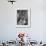 Nurse Sitting at Table with Medical Supplies While Doctors Examine Patient in Background-Wallace Kirkland-Framed Premium Photographic Print displayed on a wall