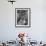 Nurse Sitting at Table with Medical Supplies While Doctors Examine Patient in Background-Wallace Kirkland-Framed Premium Photographic Print displayed on a wall