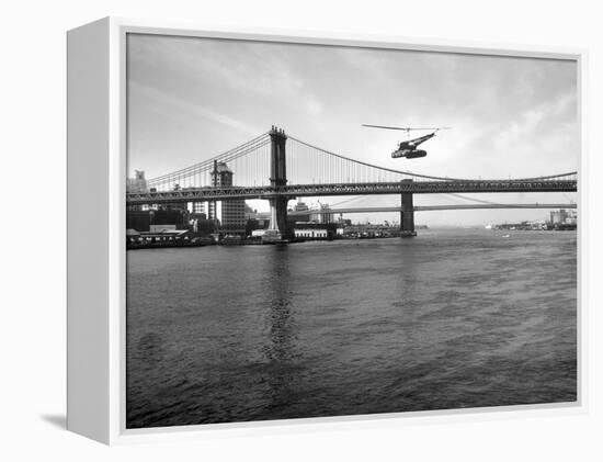 NYC Police Helicopter Hovering over the East River Next to the Manhattan Bridge-null-Framed Premier Image Canvas