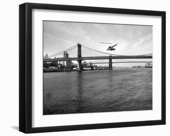 NYC Police Helicopter Hovering over the East River Next to the Manhattan Bridge-null-Framed Photographic Print