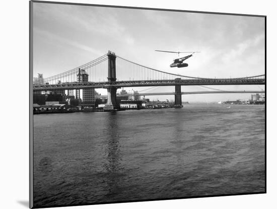 NYC Police Helicopter Hovering over the East River Next to the Manhattan Bridge-null-Mounted Photographic Print