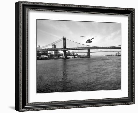 NYC Police Helicopter Hovering over the East River Next to the Manhattan Bridge-null-Framed Photographic Print
