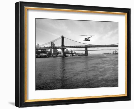 NYC Police Helicopter Hovering over the East River Next to the Manhattan Bridge-null-Framed Photographic Print