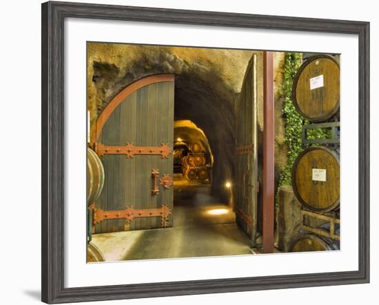 Oak Barrels Stacked Outside of Open Door To Aging Caves at Ironstone Winery, California, USA-Janis Miglavs-Framed Photographic Print