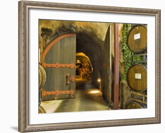 Oak Barrels Stacked Outside of Open Door To Aging Caves at Ironstone Winery, California, USA-Janis Miglavs-Framed Photographic Print